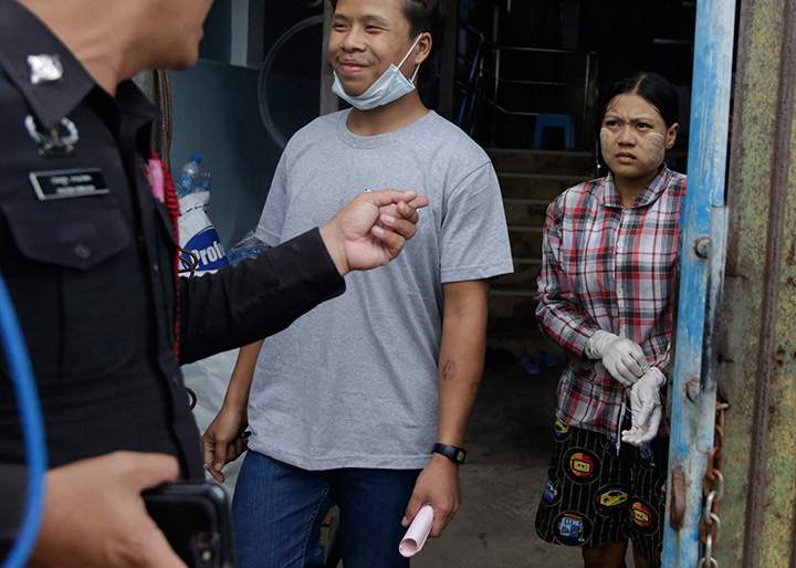 In this Monday, Nov. 9, 2015 photo, Burmese worker Tin Nyo Win, who was given the identification No. 31 at a shrimp shed where he and his wife worked, smiles as he is reunited with his wife Mi San in Samut Sakhon, Thailand. They were separated when the couple tried to escape from the shrimp shed where they were working. She was caught by the shed’s manager. He sought help from a local labour rights group that prompted police to take action.