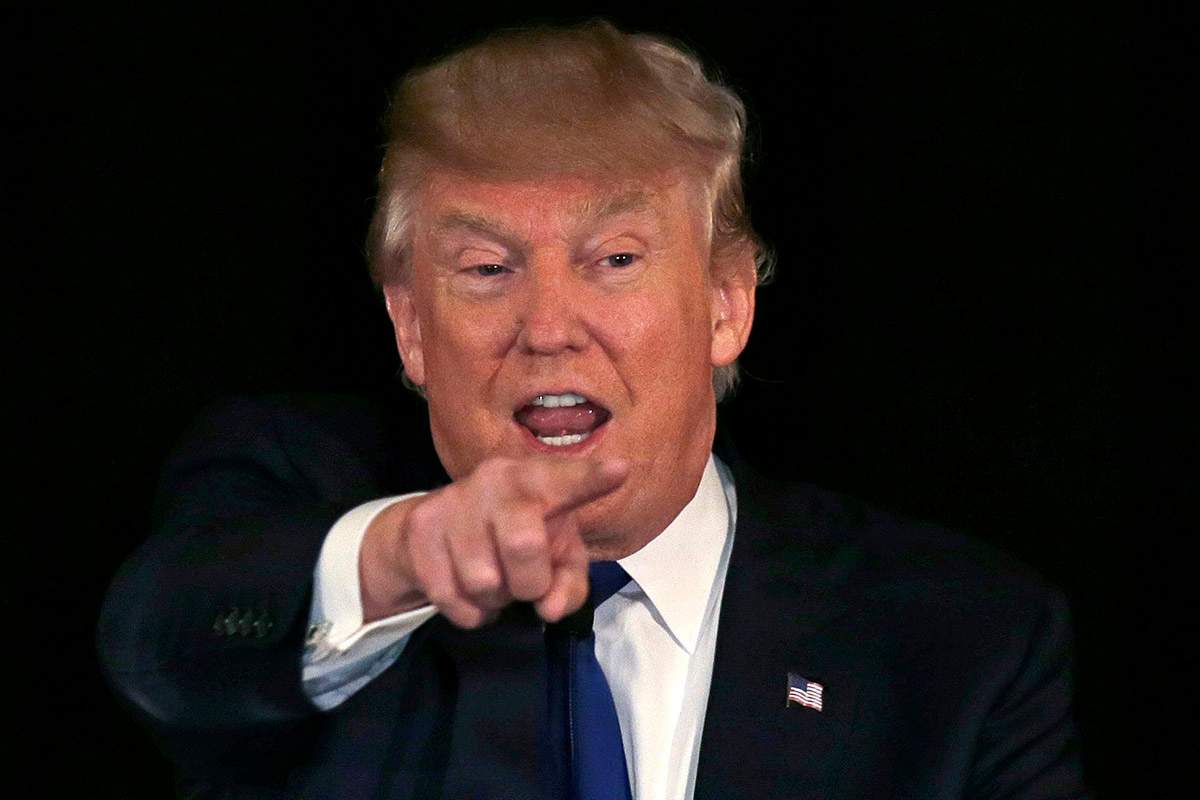In this Dec. 10, 2015, photo, Republican presidential candidate, businessman Donald Trump gestures during an address at a regional police union meeting in Portsmouth, N.H. T.