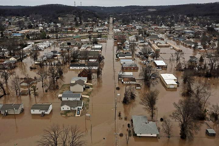 This photo shows a northern view of 1st Street where homes were flooded on Tuesday, Dec. 29, 2015, in Pacific, Mo.