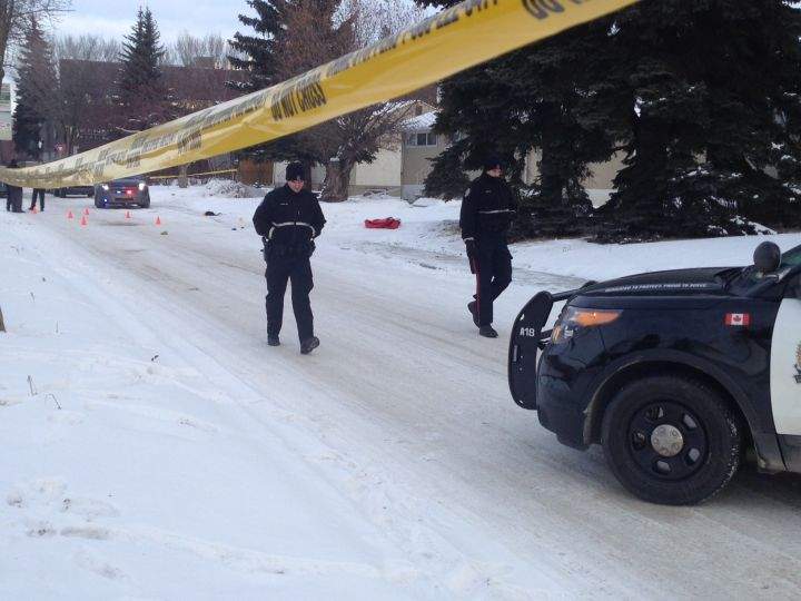 Police officers patrol the scene where a man was shot by officers in west Edmonton Saturday night.