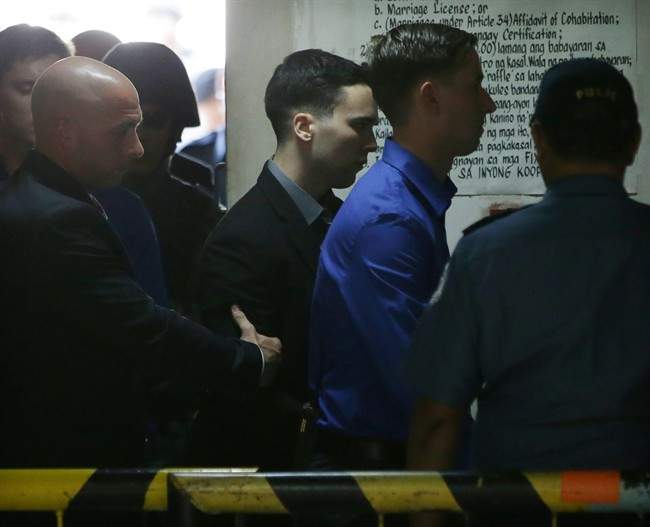 U.S. Marine Pfc. Joseph Scott Pemberton, center, the suspect in the killing of Filipino transgender Jennifer Laude, is escorted inside the courts at Olongapo city, Zambales province, northwest of Manila, Philippines on Tuesday Dec. 1, 2015. (AP Photo/Aaron Favila).