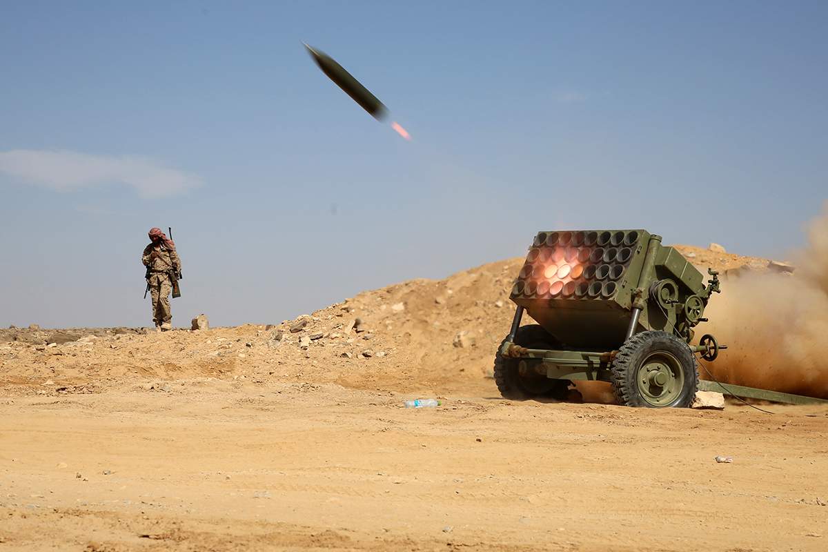 Armed Yemeni tribesmen from the Popular Resistance Committees, supporting forces loyal to Yemen's Saudi-backed President Abedrabbo Mansour Hadi, fire as they hold a position in the area of Sirwah, west of Marib city, on December 18, 2015.
   AFP PHOTO / ABDULLAH AL-QADRY / AFP / ABDULLAH AL-QADRY        (Photo credit should read ABDULLAH AL-QADRY/AFP/Getty Images).