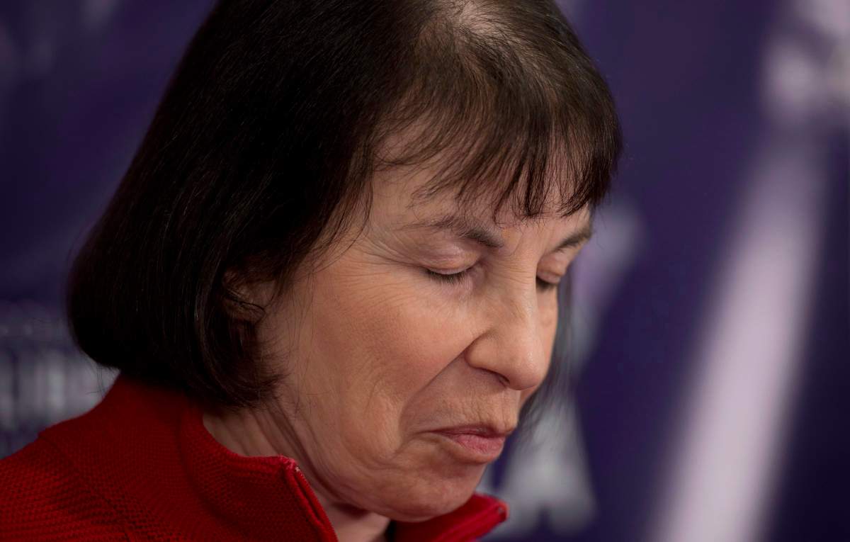 Elayne Shapray, who suffers from multiple sclerosis, pauses for a moment during a news conference in Vancouver, B.C. Tuesday, Oct. 29, 2013. 