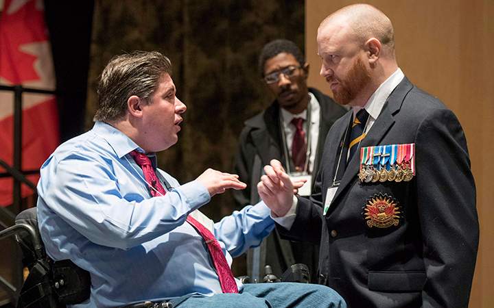 Minister of Veterans Affairs Kent Hehr speaks with veteran Brian McKenna, representing the 39 Brigade Group Wellbeing Network, at a stakeholder summit at the Canadian War Museum in Ottawa.