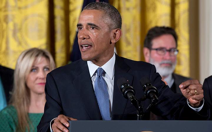 As tears flow from his eyes, President Barack Obama speaks in the East Room of the White House in Washington, about steps his administration is taking to reduce gun violence. 