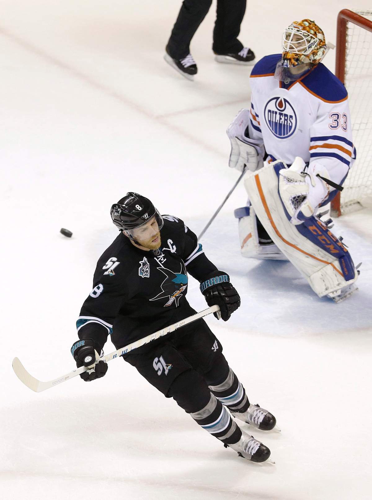 San Jose Sharks center Joe Pavelski, left, skates away after scoring on a goal against Edmonton Oilers goalie Cam Talbot (33) during a shootout of an NHL hockey game in San Jose, Calif., Thursday, Jan. 14, 2016. The Sharks won 2-1 in a shootout.