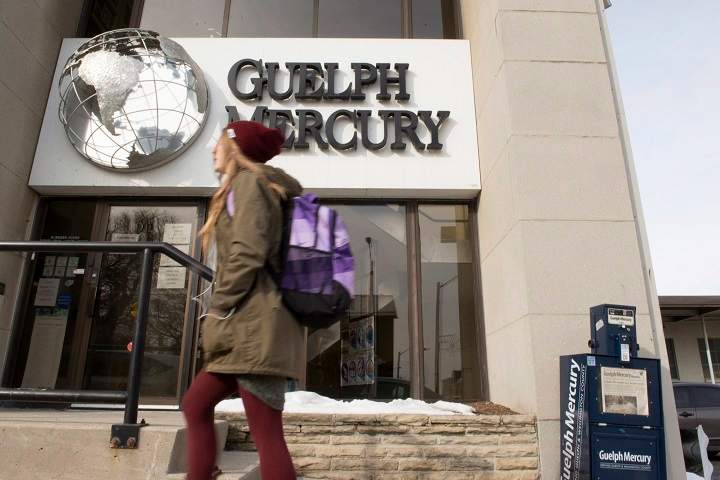 A woman walks by the Guelph Mercury office in Guelph, Ont. on Monday, Jan. 25, 2016. The Guelph Mercury daily newspaper has announced it will stop publishing its print editions this week with 23 full-time and three part-time jobs being affected.