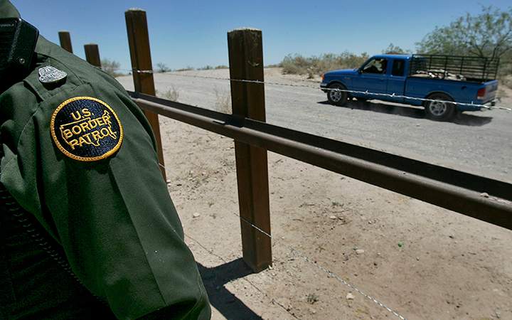 A truck passes on the Mexican side of the border with Arizona.