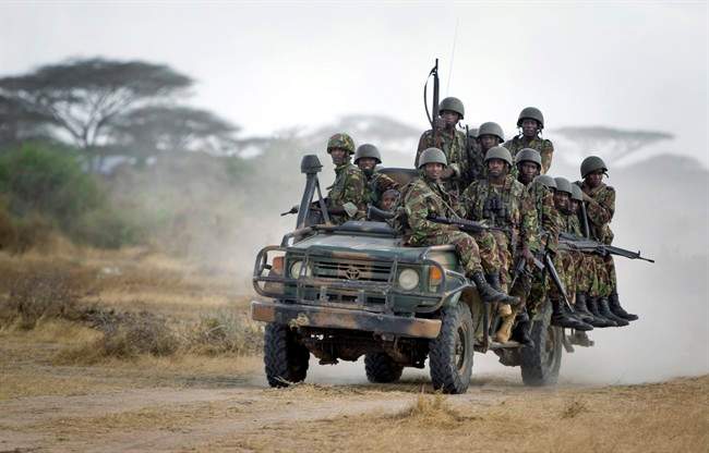 In this Monday, Feb. 20, 2012 file photo, Kenyan army soldiers ride on a vehicle at their base in Tabda, inside Somalia. 