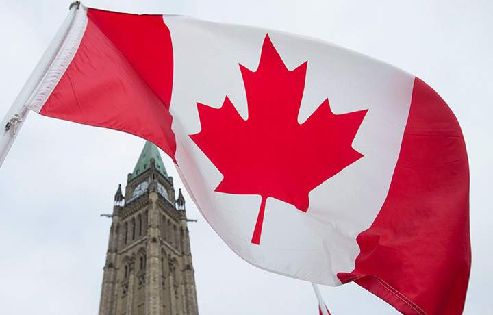 The Canadian flag flies on Parliament Hill in Ottawa.