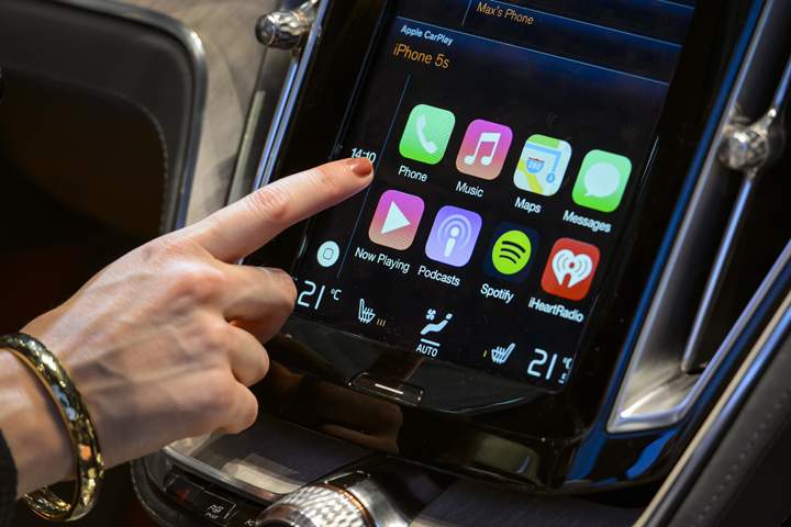 A visitor presses the new Apple’s CarPlay touch-screen commands.