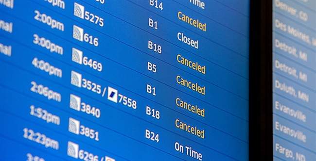 Flight boards at O'Hare International Airport show cancellations Friday, Jan. 22, 2016 in Chicago.