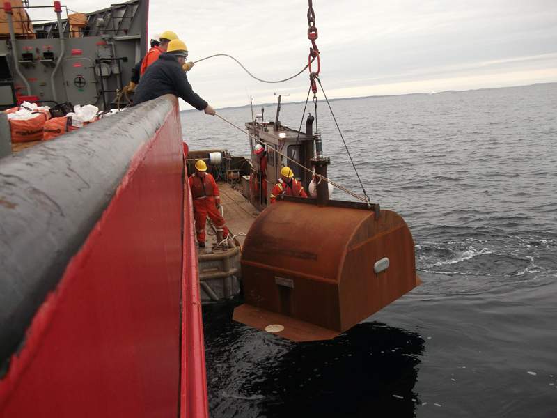 A cofferdam is placed in the water near the site of the Manolis L