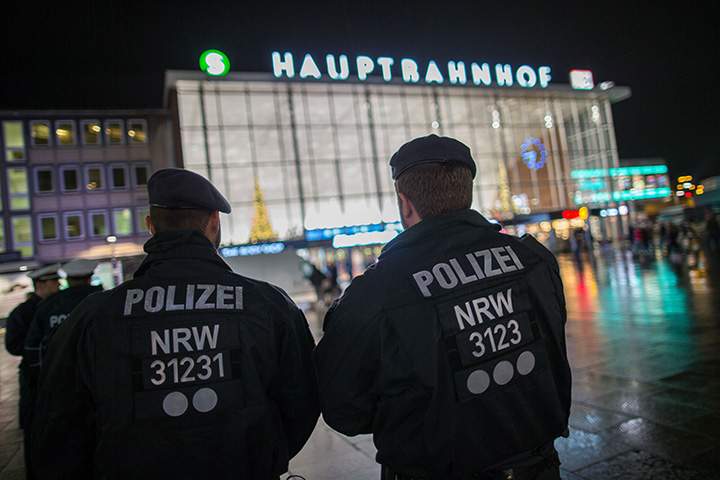 Police officers survey the area in front of the main train station and the Cathedral in Cologne, western Germany, on January 6, 2016.  