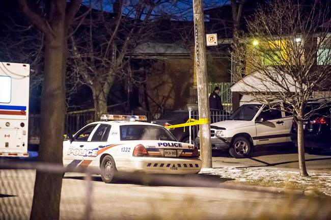 Police investigate a death in Toronto Friday, Jan. 29, 2016. Police have one man in custody in connection with the death of an 87-year old man in a central Toronto neighbourhood Friday afternoon.