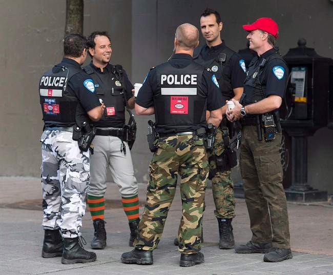 Montreal Police officers are shown on a street in Montreal on August 7, 2014.