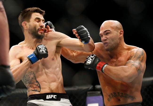 Robbie Lawler, right, hits Carlos Condit during a welterweight championship mixed martial arts bout at UFC 195, Saturday, Jan. 2, 2016, in Las Vegas. Lawler made a basic purse of US$500,000 for his hard-earned split-decision win over challenger Condit on Saturday at UFC 195.THE CANADIAN PRESS/AP/John Locher.