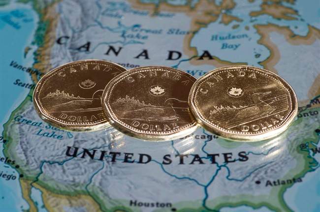 Canadian dollar coins are displayed on a map of North America on January 9, 2014 in Montreal. The Canadian dollar slipped below 70 cents U.S. on Wednesday for the second day in a row as the currency traded near lows set nearly 13 years ago.