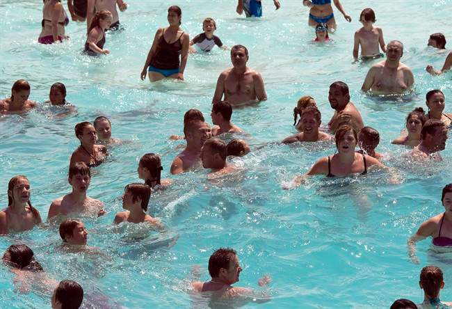 Bathers bob in the wave pool to beat the 30C heat at the Super Aqua club, Tuesday, July 28, 2015 in Pointe-Calumet, Que.
