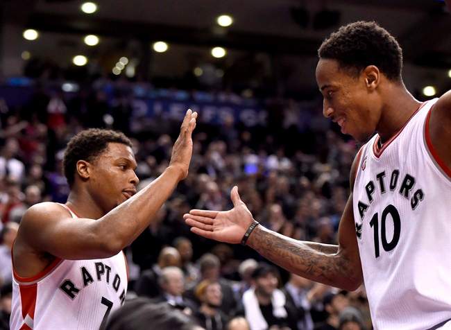 Toronto Raptors' DeMar DeRozan (10) and Kyle Lowry celebrate the dying seconds of their win over the Brooklyn Nets.