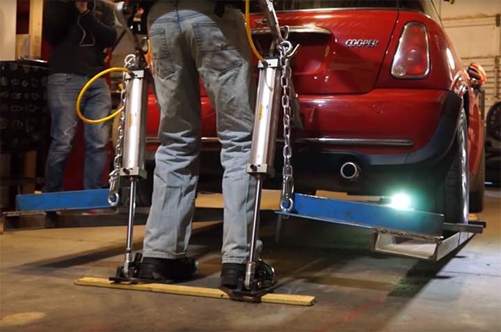 James Hobson’s homemade exoskeleton legs are seen lifting a Mini Cooper in a YouTube video posted on Jan. 25, 2016.