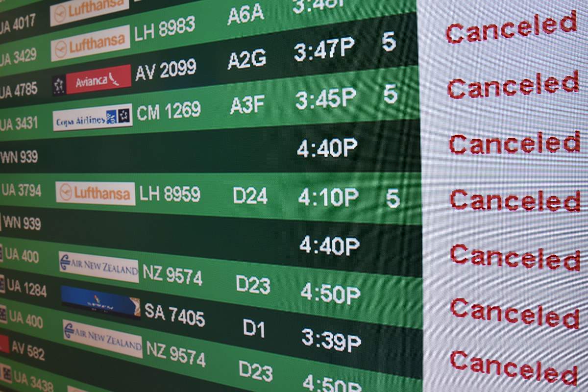 One of the flight status board for arrivals and departures is viewed at Dulles International Airport(IAD) just outside Washington, DC, January 22, 2016 in Sterling, Virginia.