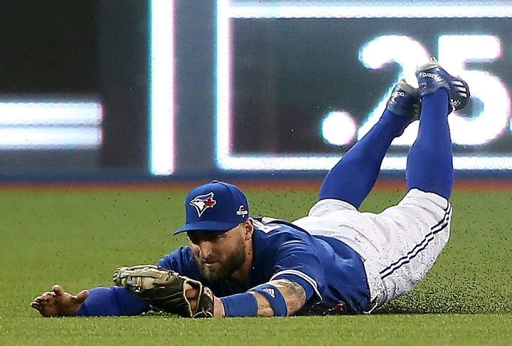 Kevin Pillar #11 of the Toronto Blue Jays makes a diving catch on a ball hit by Josh Hamilton #32 of the Texas Rangers in the fourth inning in game five of the American League Division Series at Rogers Centre on October 14, 2015 in Toronto, Canada. (Photo by Tom Szczerbowski/Getty Images).