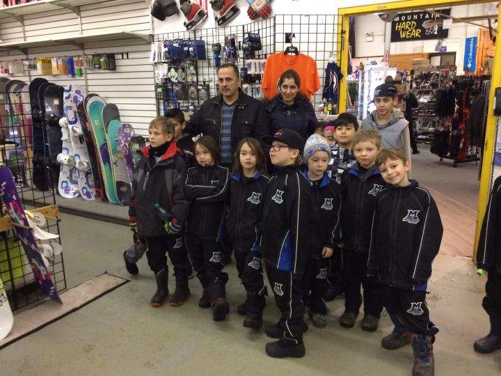 The Mansour family poses for a picture with the Millwood Wolves.