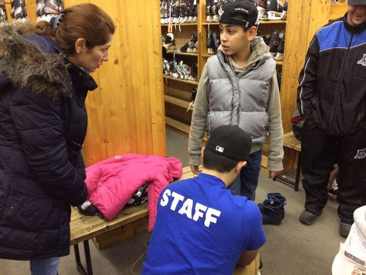 Kanan Mansour, 12, gets fitted for a pair of skates.