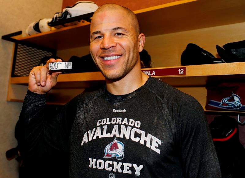 Colorado Avalanche right wing Jarome Iginla holds up the puck in the locker room after he scored his 600th career goal in an NHL hockey game against the Los Angeles Kings, Monday, Jan. 4, 2016, in Denver. Colorado won 4-1.