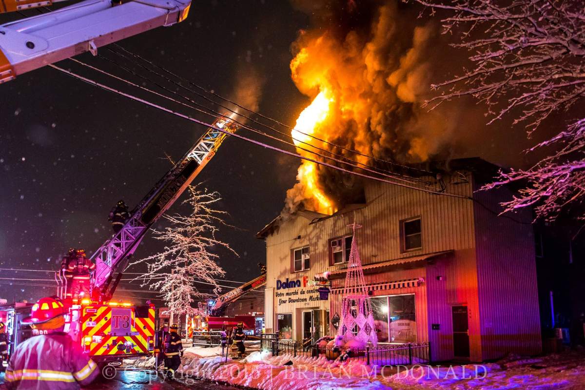 Firefighters work to put out a blaze that destroyed three apartments and displaced five people in a building on St. George St. on Sunday night.