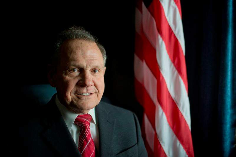  In this Feb. 17, 2015, file photo, Alabama Chief Justice Roy Moore poses in front the the American flag in Montgomery, Ala. Moore issued an administrative order Wednesday, Jan. 6, 2016, saying the Alabama Supreme Court never lifted a March 2015 directive to probate judges to refuse licenses to gay couples. He said the order to refuse the licenses remains in "full force" despite the U.S. Supreme Court ruling more than six months ago that effectively legalized same-sex marriage throughout the country. 