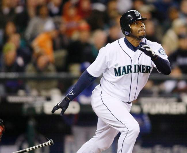 This is an Oct. 3, 2009, file photo showing Seattle Mariners' Ken Griffey Jr. hitting a solo home run on a pitch from Texas Rangers' Tommy Hunter during the fourth inning of a baseball game in Seattle.