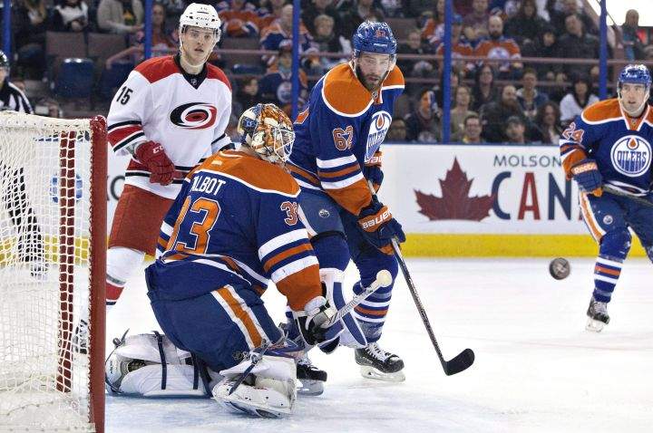 Carolina Hurricanes' Andrej Nestrasil (15) and Edmonton Oilers' Eric Gryba (62) look for the rebound from goalie Cam Talbot (33) during first period NHL action in Edmonton, Alta., on Monday January 4, 2016. 