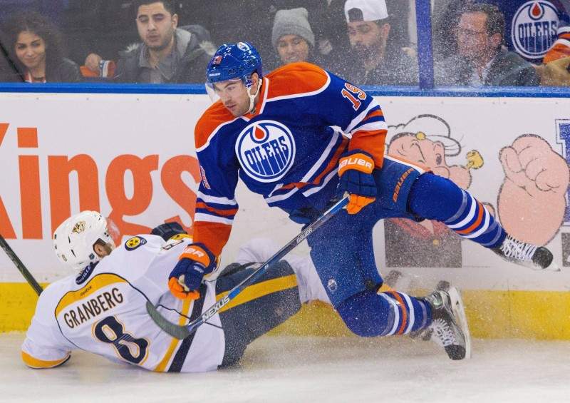 Nashville Predators’ Petter Granberg (8) and Edmonton Oilers’ Justin Schultz (19) collide during second period NHL hockey action in Edmonton, Alta., on Saturday January 23, 2016. THE CANADIAN PRESS/Amber Bracken