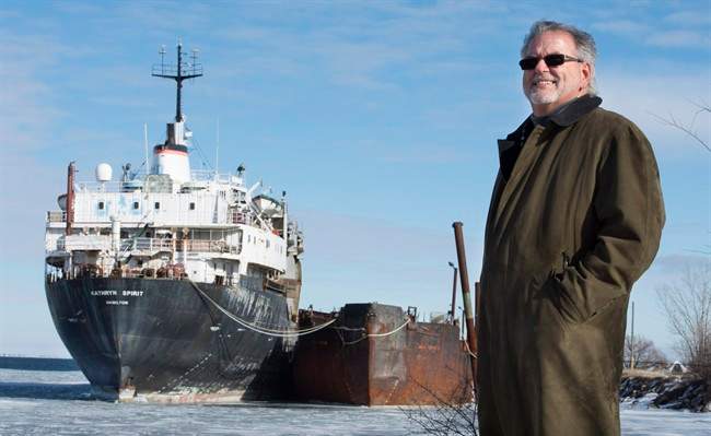 Beauharnois mayor Claude Haineault stands next to the Kathryn Spirit Wednesday, January 27, 2016 in Beauharnois, Que. Concerns are that the derelict cargo ship anchored off the town's shore could sink, spilling toxic material into Montreal's drinking water supply.