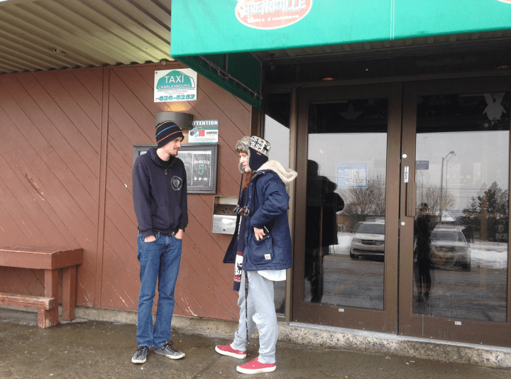 Arcade-goers wait outside as police investigate the death of a 19-year-old man who was crushed by a game, Thursday, January 7, 2016.