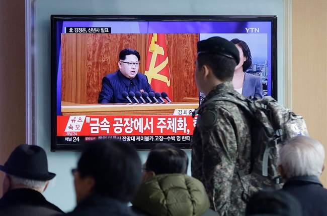 A South Korean army soldier passes by a TV news program showing North Korean leader Kim Jong Un's New Year speech, at the Seoul Railway Station in Seoul, South Korea, Friday, Jan. 1, 2016.