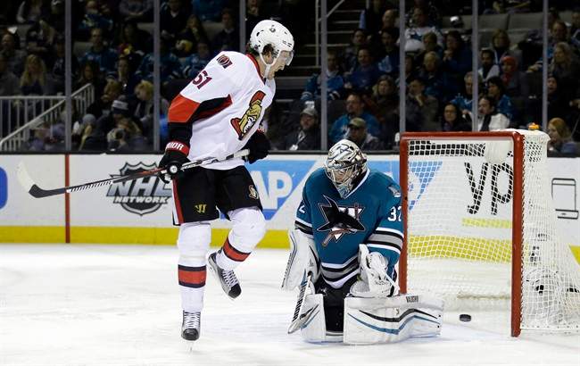 San Jose Sharks goalie Alex Stalock, right, is beaten for a goal on a shot from Ottawa Senators\’ Bobby Ryan, not seen, as Mark Stone (61) watches during the second period of an NHL hockey game Monday, Jan. 18, 2016, in San Jose, Calif.