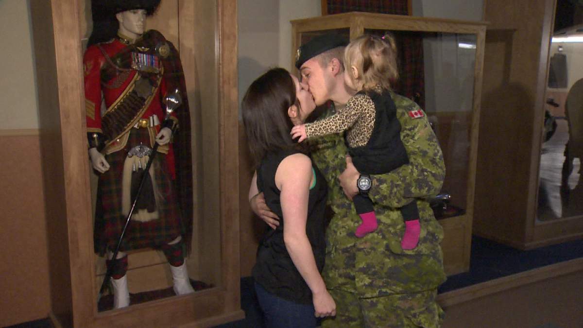Corp. Thoman Fitzptrick embraces his family in Fredericton on Tuesday. He returned from a mission in Lebanon, where he was helping to process Syrian refugees coming to Canada.