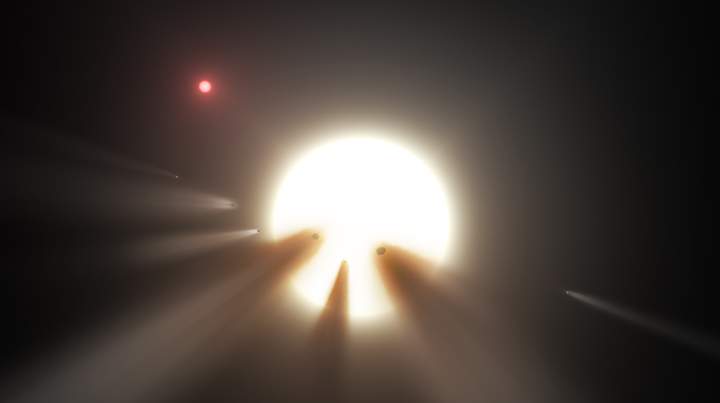 An illustration of a star surrounded by pieces of a shattered comet.