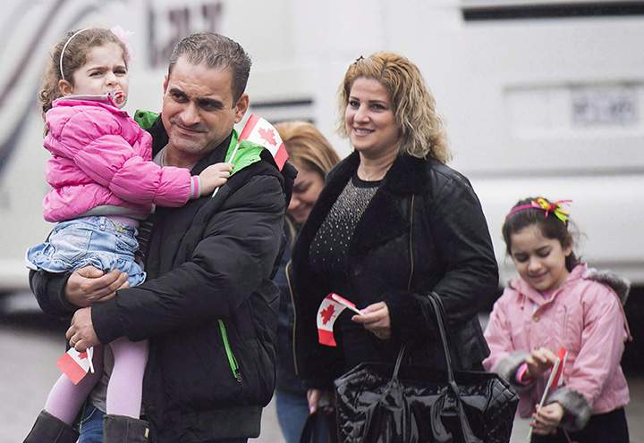 Newly-arrived Syrian refugees meet sponsors and relatives at the Armenian Community Centre in Toronto on Wednesday, December 16, 2015. 
