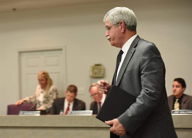 Hamilton County Schools Superintendent Rick Smith enters a school board meeting room before a short public meeting in Chattanooga, Tenn., Wednesday, Jan. 6, 2016. Tennessee's Ooltewah High School has called off the rest of its basketball season after three of its players were arrested on charges of raping a teammate in an apparent hazing incident. 