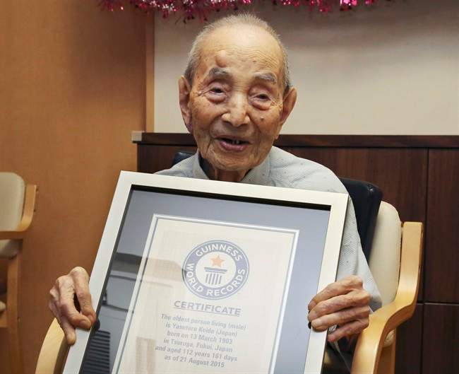 FILE - In this Aug. 21, 2015, file photo, Yasutaro Koide, 112, holds the Guinness World Records certificate as he is formally recognized as the world's oldest man at a nursing home in Nagoya, central Japan. Koide, who was born on March 13, 1903, has died on Tuesday, Jan. 19, 2016, two months short of his 113th birthday. (AP Photo/Koji Sasahara, FIle).