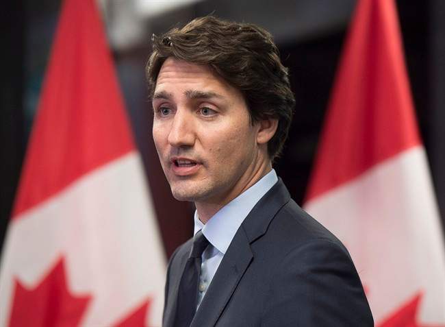 Prime Minister Justin Trudeau talks with reporters in Davos, Switzerland on Friday, Jan. 22, 2016. 