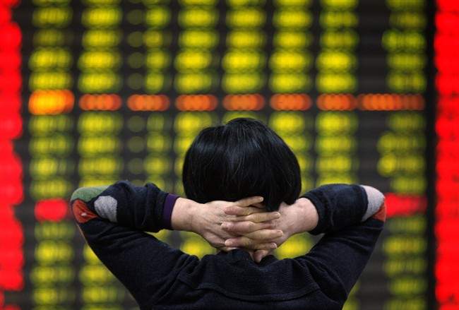 A Chinese investor monitors stock prices at a brokerage house in Huaibei in central China's Anhui province Friday, Jan. 15, 2016.