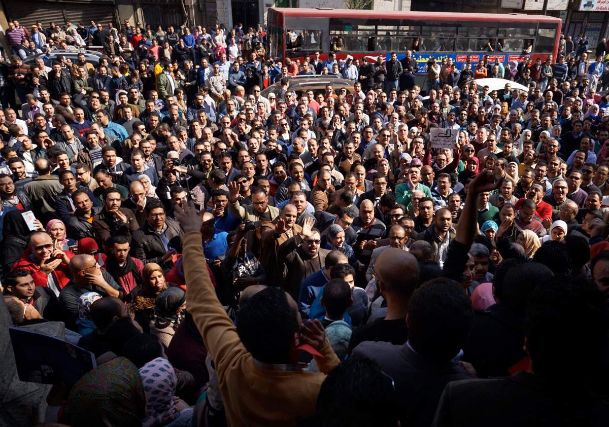 Egyptian doctors stage a protest against rampant police abuses, after two doctors were beaten up by policemen in a Cairo hospital, in front of their headquarters of the Egyptian Medical Syndicate in Cairo, Egypt, Friday, Feb. 12, 2016.