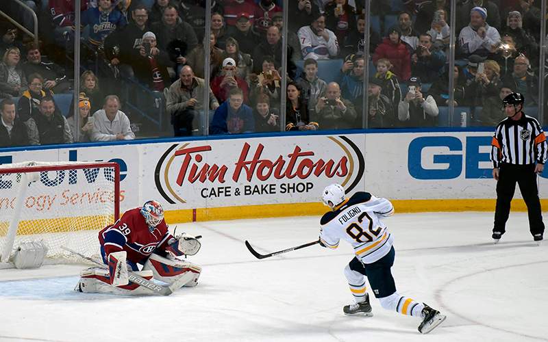 Buffalo Sabres' Marcus Foligno scores on a penalty shot over the glove of Montreal Canadiens' Mike Condon during the second period of an NHL hockey game, Friday, Feb. 12, 2016, in Buffalo, N.Y. 