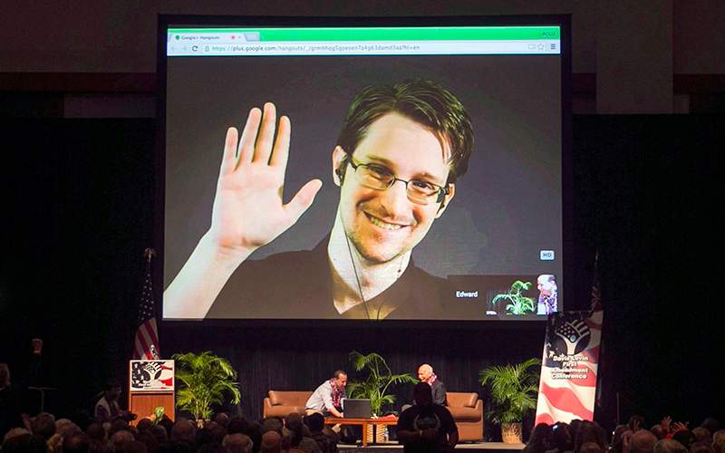 Edward Snowden appears on a live video feed broadcast from Moscow at an event sponsored by ACLU Hawaii in Honolulu on Feb. 14, 2015. 