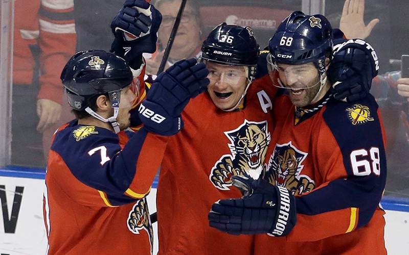 Florida Panthers right wing Jaromir Jagr celebrates with teammates Jussi Jokinen and Dmitry Kulikov after scoring against the Winnipeg Jets during the second period of an NHL hockey game, Saturday, Feb. 20, 2016, in Sunrise, Fla. 